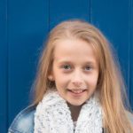 girl-infront-of-blue-wall-child-photo-shoot