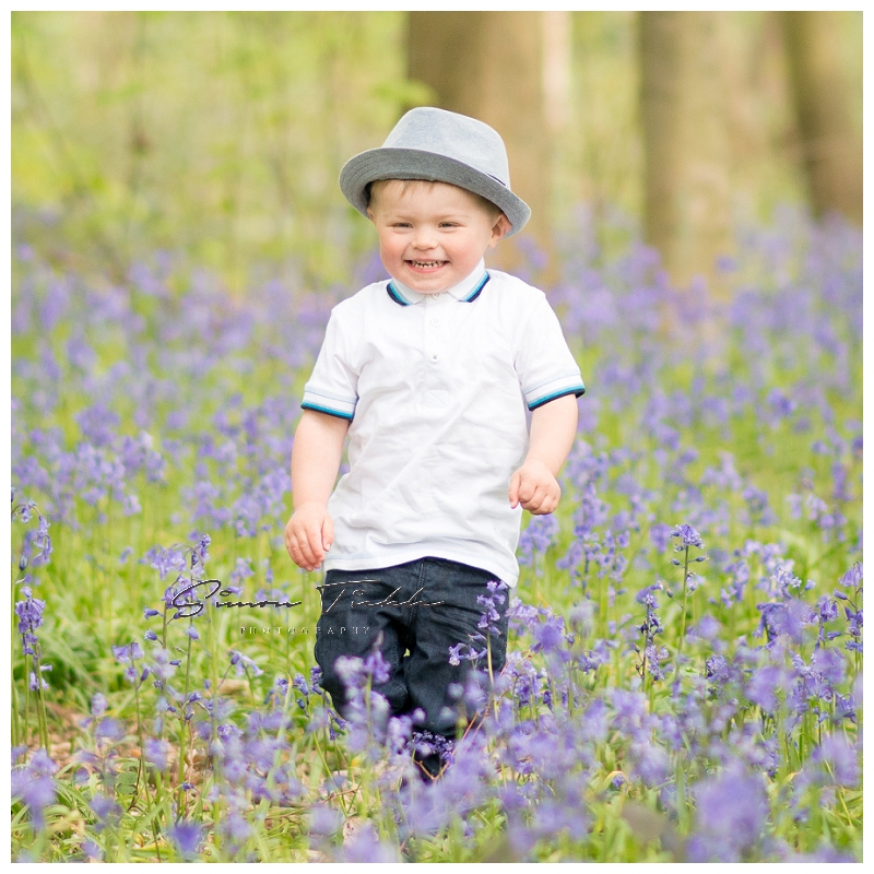 boy wearing hat wanders in bluebells - child photo shoot nottingham